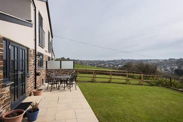 The garden has a privacy screen between the cottage and next door.