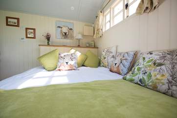 The king-size double bed has a window at the end and if you ever bore of the lovely view, there is a TV too!