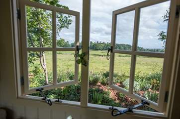 The view from your kitchen window across open fields which are grazed with cattle and sheep.