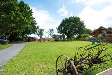 There is a reminder you are on a working farm with clever use of old farm machinery as garden ornaments. Your parking area is to the left of the photograph.