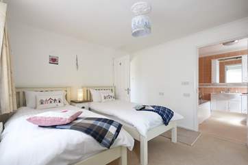 The twin bedroom looking through to the en suite bathroom.