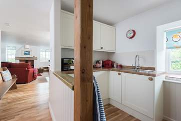 The small but perfectly formed kitchen also has a utiilty-room opposite with the washing machine and a drying rack.