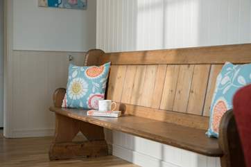 There is a lovely old wooden pew in the hallway.
