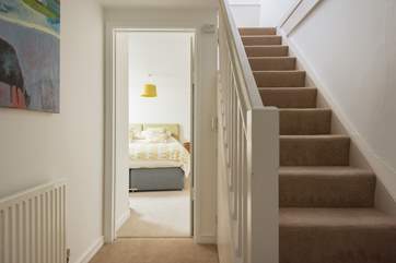 The stairs rising to the first floor living-room, kitchen and front door.