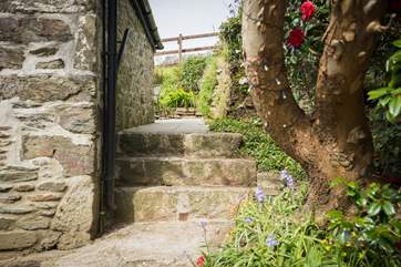 The stone steps to the side of the cottage take you to the courtyard garden.