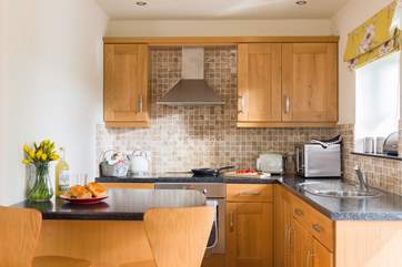 The surprisingly spacious and well-equipped kitchen with dining at the breakfast-bar.