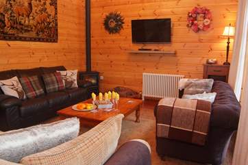 The cosy seating area has an electric wood burner effect stove and three