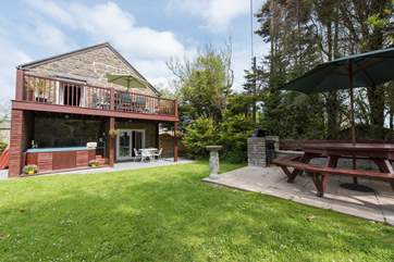 The hot tub is sheltered under the balcony.