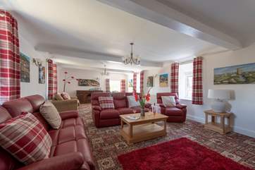 The huge sitting-room has a roaring open-fire.