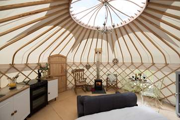 The main yurt has a fully fitted kitchen (including oven and fridge) a wood-burner, dining-area and the lovely king-size bed.