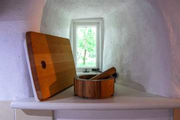 A tiny window looks out from the kitchen over a sheltered village green space.