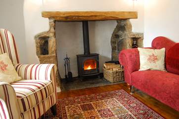 A wood-burner in the original inglenook fireplace keeps the cottage toasty warm.