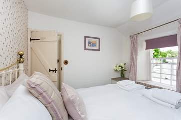 The master bedroom is furnished in soft pastels.