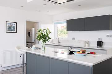 The useful utility-room is located just off the kitchen and has a washing machine and tumble-drier.