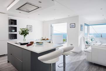 The open plan living-room with areas to cook, eat and relax.