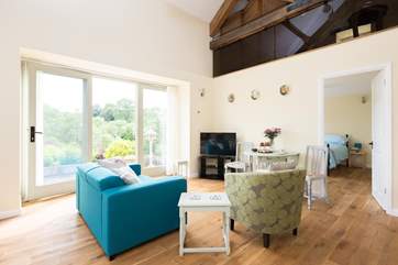 The lovely double height open plan living area has French windows out onto the terrace.