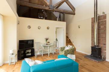 The second bedroom is up the stairs in one of two mezzanine areas. The wood-burning stove is ornamental - but the Studio is so snug in any case.