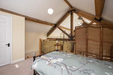 The single bedroom is on one of the two mezzanine levels. The clever screen ensures privacy but you will have all the upstairs space to yourself.