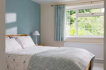 This bedroom is light and spacious and decorated in calm colours.