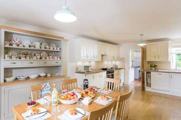 The very spacious and well-equipped kitchen/diner with the utility-room beyond with the door out to the garden.