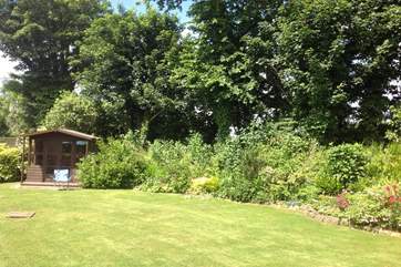 The pretty back garden is a tranquil and private place with plenty of room to run around.