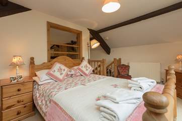 This photographs shows the stairs leading up into the master bedroom.