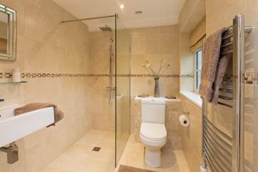 This bedroom has a spacious wet-room style shower.