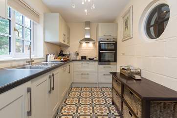 Another view of the kitchen - a very attractive and practical room with plenty of storage space for your own provisions.