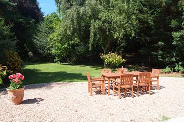 The lovely gardens are bordered by mature trees.