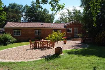 The Coach House Stables has a beautiful sheltered back garden with view from the end over the fields. The entrance and parking is on the far side.