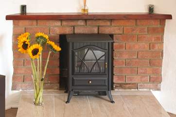 The electric fire gives off a warm glow.