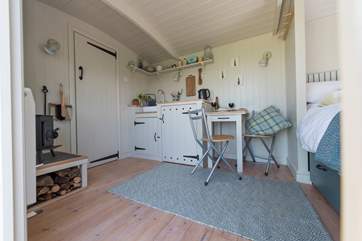 It has a little dining-area and kitchen-area with very clever use of storage (the combination microwave and toaster are hidden behind the cupboard doors).