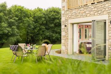 The large lawned garden wraps around the front and side of the house.