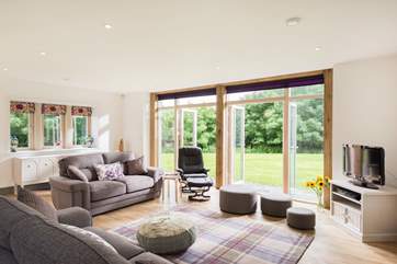 Two sets of French doors open onto the garden from the spacious sitting-room.