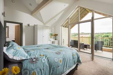 The fabulous master bedroom has a balcony and there are fully lined curtains now at the window.