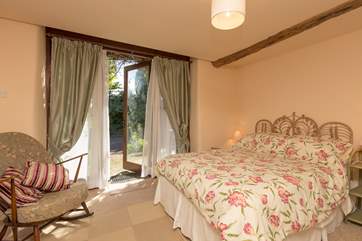 This is the ground floor double bedroom, with French Windows to the patio outside.