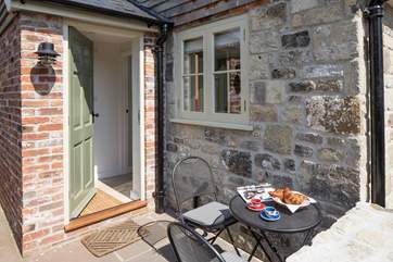 The little terrace catches the sun and is ideal for morning coffee. The enclosed garden is through the gate to the left of this photograph.