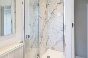 The first floor family bathroom has a shower cubicle as well as a bath.