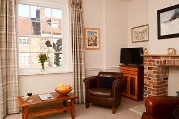 The cosy sitting-room is separate from the open plan space, with another television,