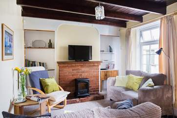 The sitting-room with feature brick fireplace and electric fire, the cottage also benefits from solar water heating and biomass central heating