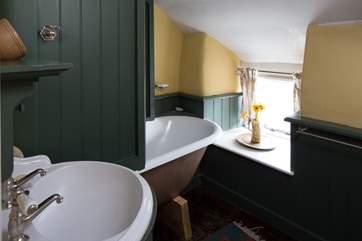 The carefully designed bathroom has a roll-top bath.