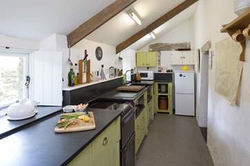 The galley-style kitchen with slate sink and worktops.