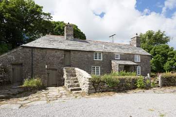 The outside of the cottage with stone steps leaDing up to bedroom 3 (not really practical to use).