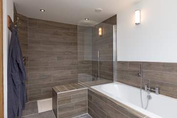 The ground floor bedroom has a bath and a walk-in shower which has been designed with built-in seating to help any guests who may have mobility problems.