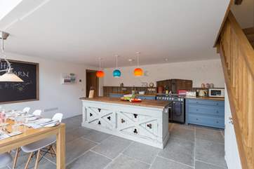 The stairs to the side of the kitchen lead up to the mezzanine sitting-room.