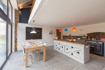 The kitchen is designed for great fun as well as being very practical and fabulously equipped. Floor to ceiling windows look out over your front garden.