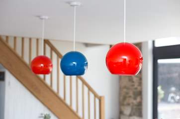 Bright colours complement the gentle decor of the kitchen.