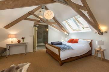 This is the first bedroom suite, reached via the stairs at the far end of the sitting-room. Please note that the angled beams are low where they meet the walls.