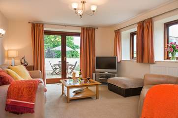 The comfortable sitting-area has double doors leading out to the patio-area.