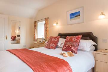 Bedrom 1 has lovely bright cushions and throws.
